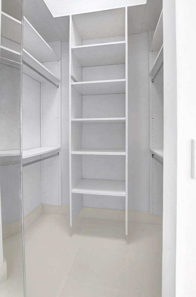 unfurnished bedroom featuring a spacious closet and a closet