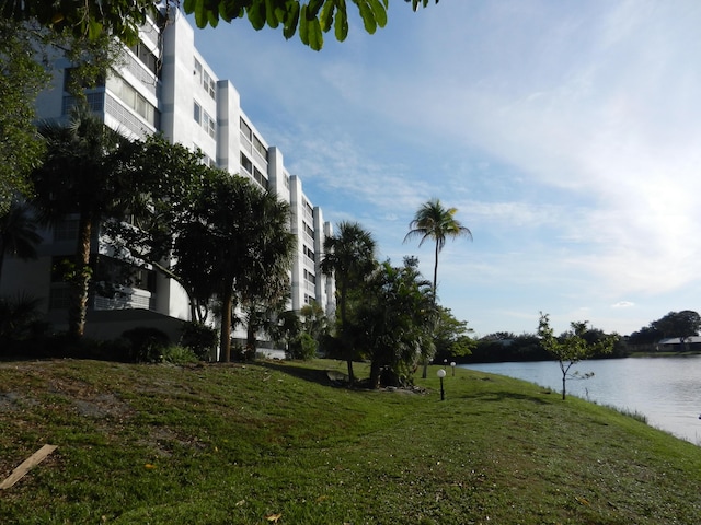 exterior space featuring a water view and a yard