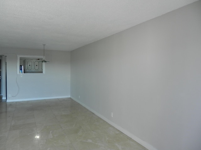 spare room featuring a textured ceiling