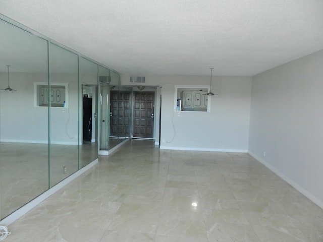 unfurnished room featuring a textured ceiling