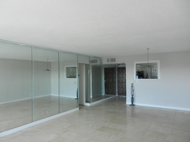 spare room with a textured ceiling