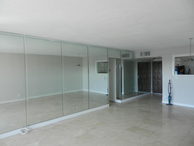 spare room featuring a textured ceiling