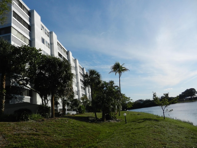 exterior space featuring a yard and a water view