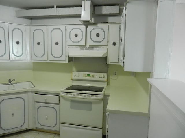 kitchen featuring white cabinetry, white electric range oven, light tile patterned flooring, and sink