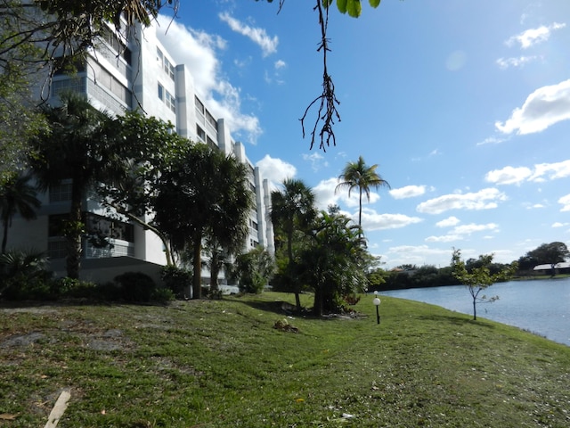 exterior space with a lawn and a water view