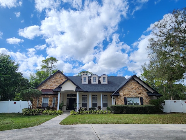 view of front of house with a porch and a front yard