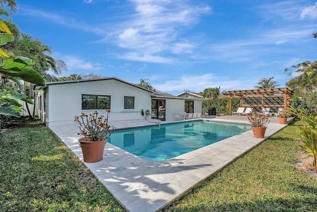 view of pool with a yard, a pergola, and a patio