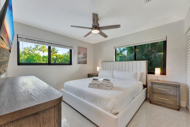 bedroom featuring multiple windows and ceiling fan