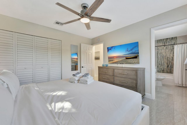 bedroom with ceiling fan, ensuite bath, and a closet