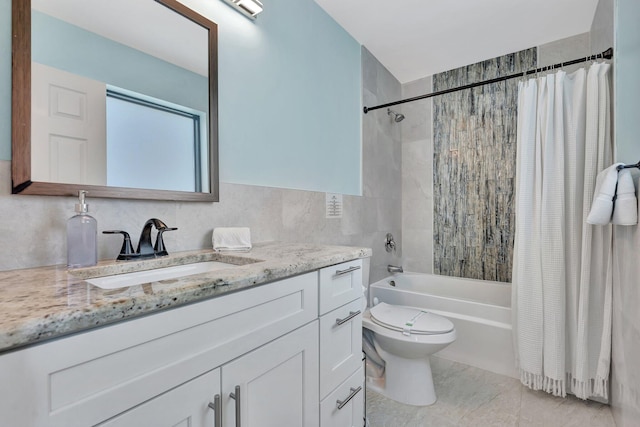 full bathroom with shower / bathtub combination with curtain, vanity, toilet, and tile walls