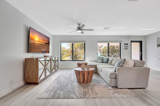 living room with ceiling fan and light hardwood / wood-style flooring