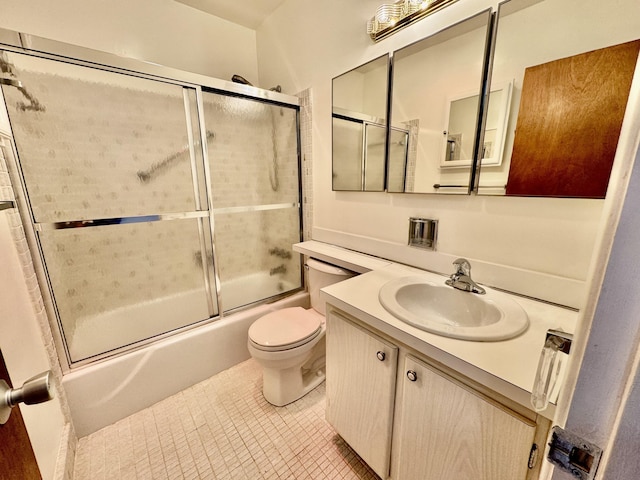 full bathroom with vanity, bath / shower combo with glass door, and toilet