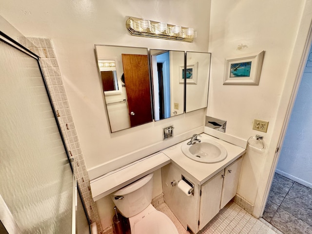 bathroom with a shower with door, vanity, and toilet