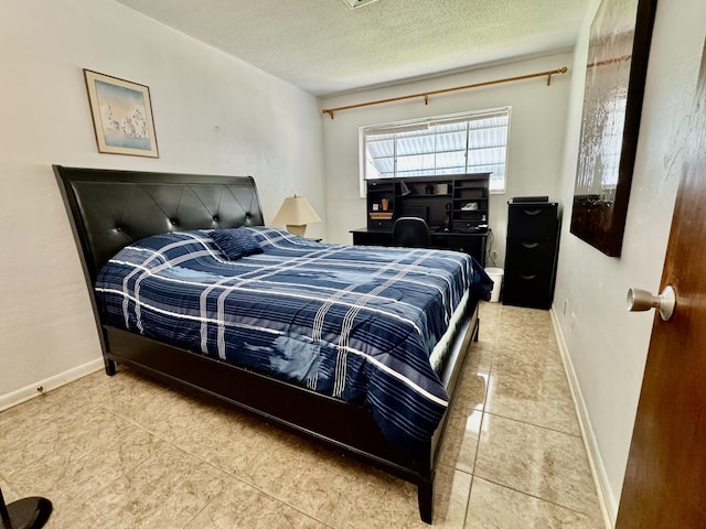 bedroom with tile patterned flooring and a textured ceiling