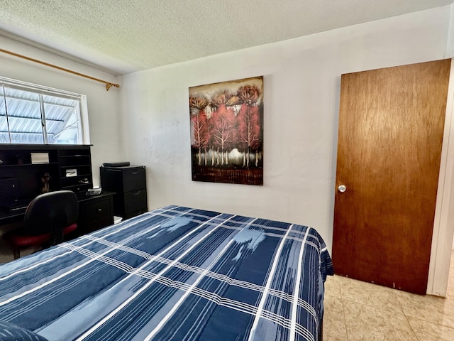 tiled bedroom with a textured ceiling