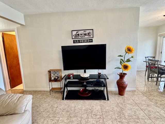 living room with tile patterned flooring and a textured ceiling