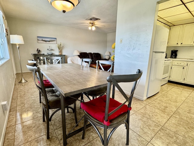 tiled dining room featuring ceiling fan