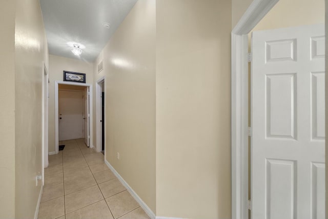 hallway featuring light tile patterned floors