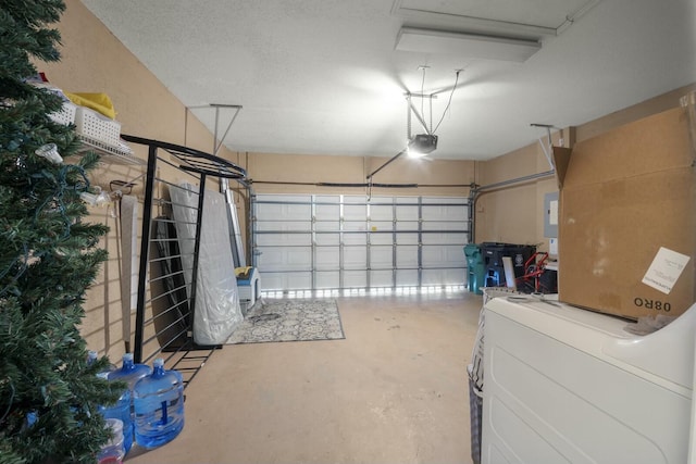 garage with washer / clothes dryer and a garage door opener