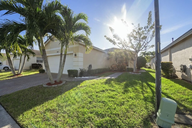 view of side of home with a yard and a garage