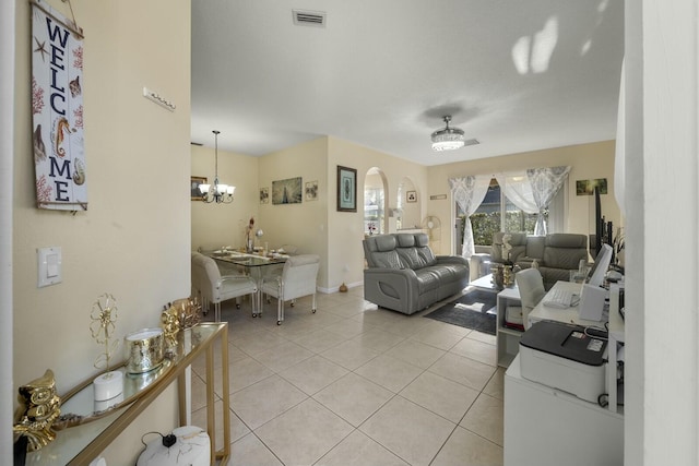 tiled living room featuring a notable chandelier