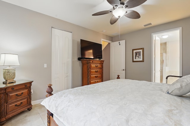 tiled bedroom with ceiling fan, connected bathroom, and a closet