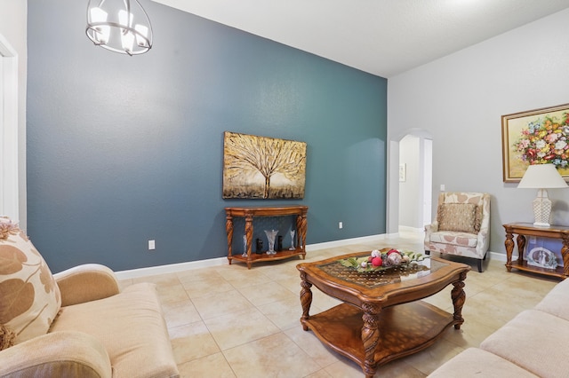 tiled living room featuring an inviting chandelier