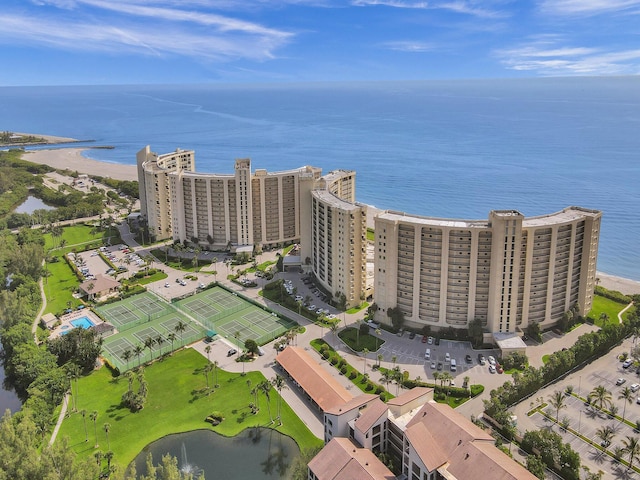 birds eye view of property with a beach view and a water view