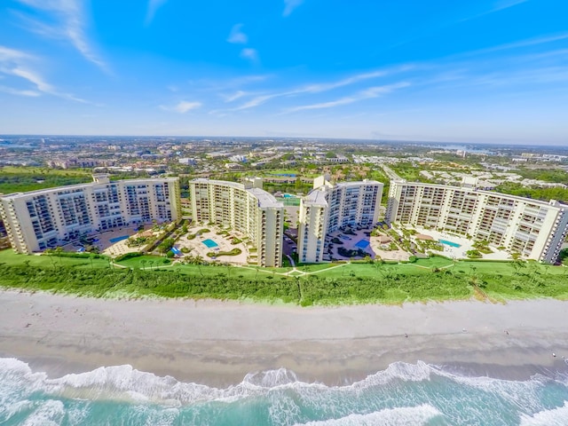 aerial view with a water view and a beach view