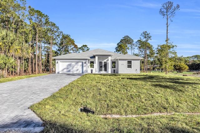 view of front facade with a garage and a front yard