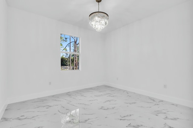 spare room featuring a notable chandelier