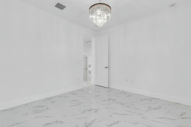 empty room featuring a notable chandelier