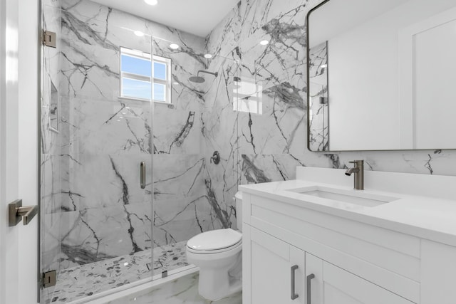 bathroom with an enclosed shower, vanity, tile walls, and toilet