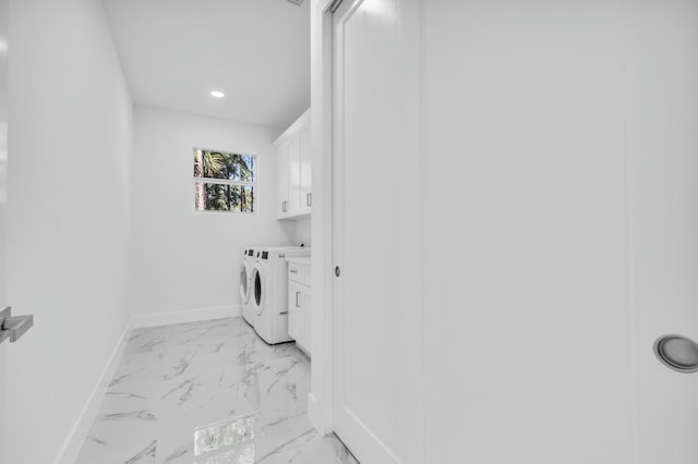 washroom with cabinets and washing machine and dryer