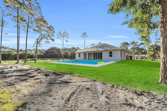 back of house featuring a patio and a yard