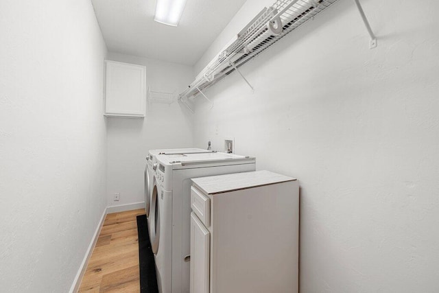 washroom featuring light wood-type flooring and washer and clothes dryer