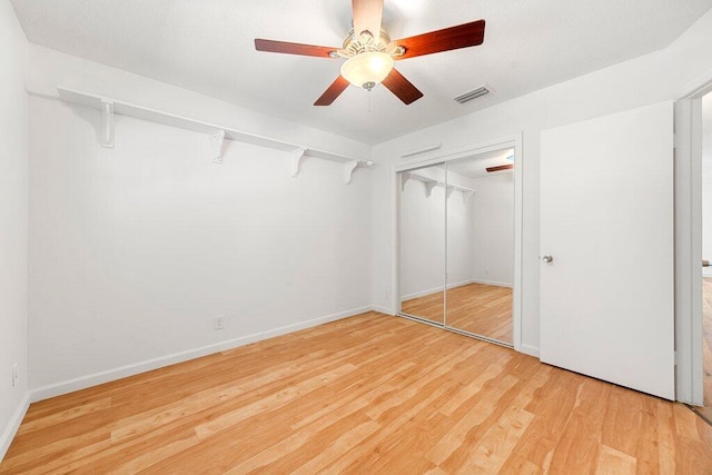 walk in closet with hardwood / wood-style flooring and ceiling fan