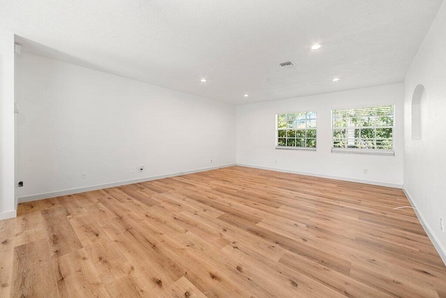 unfurnished room with light wood-type flooring