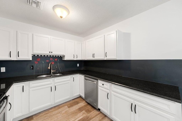 kitchen featuring white cabinetry, appliances with stainless steel finishes, sink, and light hardwood / wood-style floors