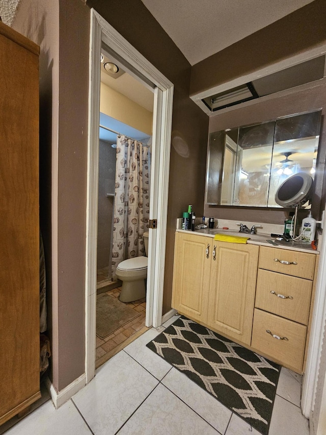 bathroom featuring vanity, tile patterned floors, toilet, and a shower with shower curtain