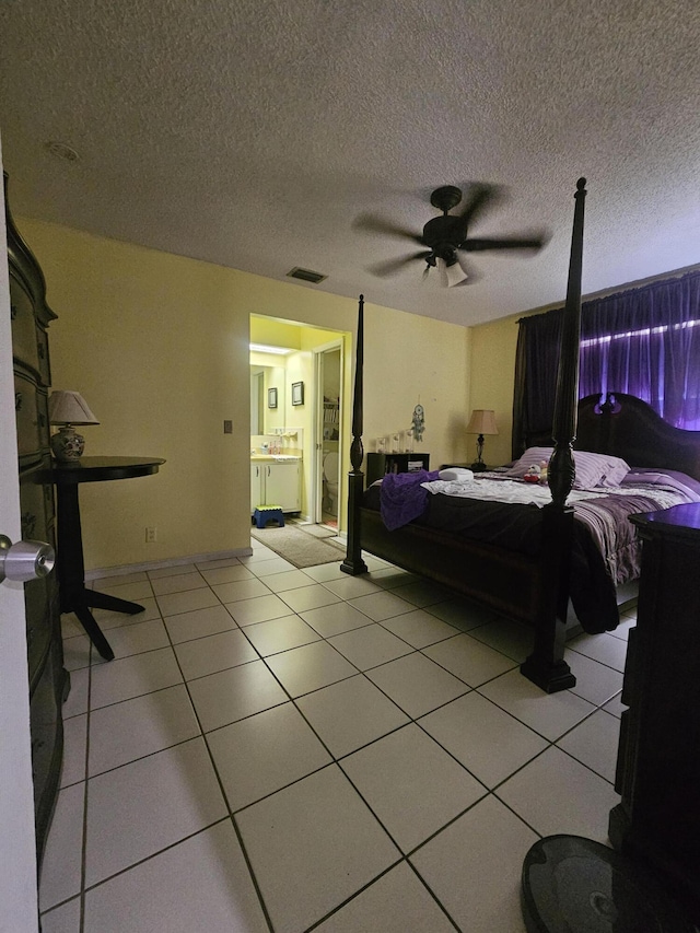 bedroom with light tile patterned floors, a textured ceiling, and ceiling fan