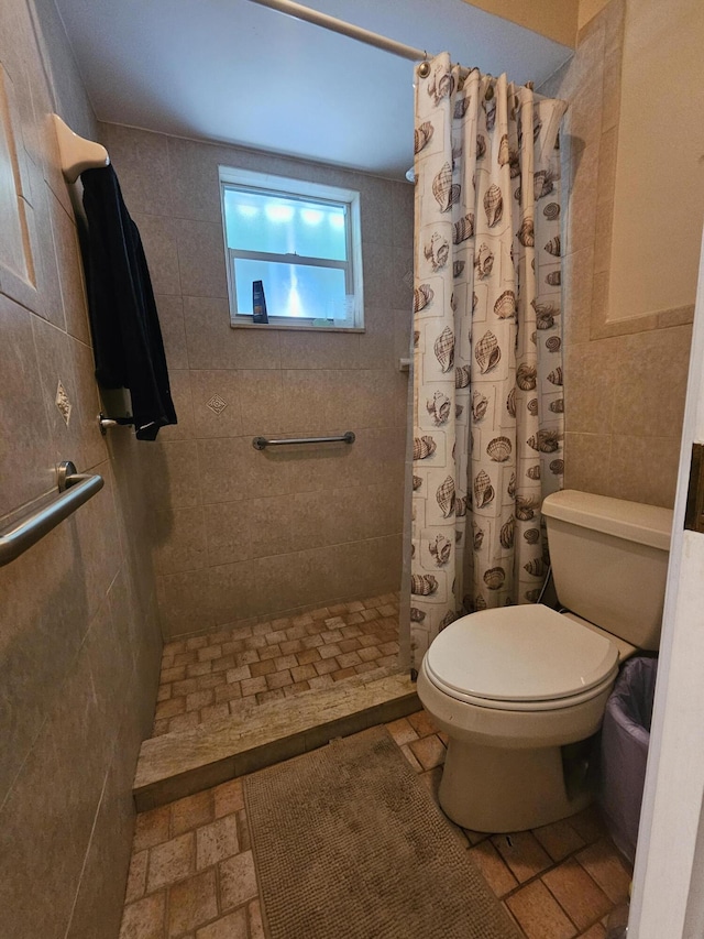 bathroom with walk in shower, toilet, and tile walls