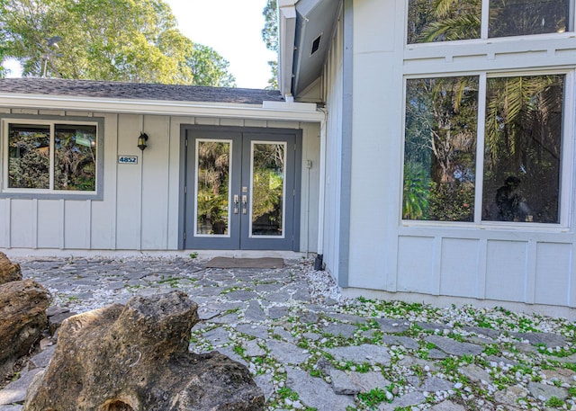 view of exterior entry featuring a patio area and french doors