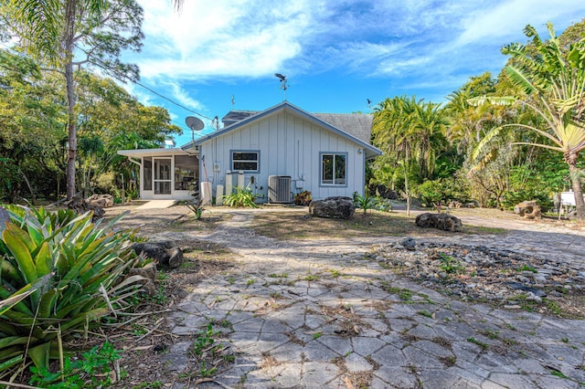 back of property featuring a patio, a sunroom, and central air condition unit