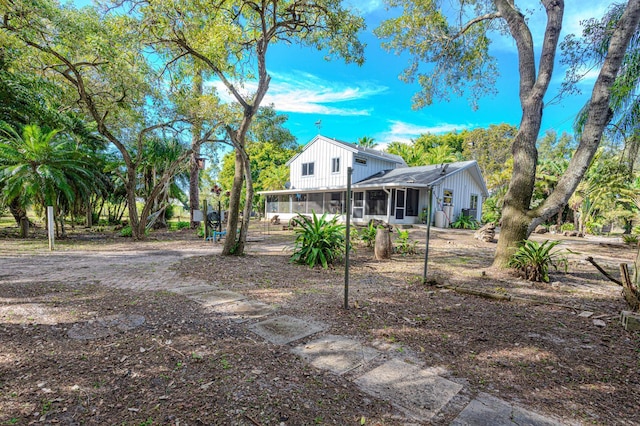 back of house featuring a sunroom