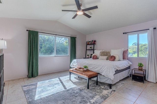 bedroom featuring lofted ceiling, light tile patterned floors, and ceiling fan