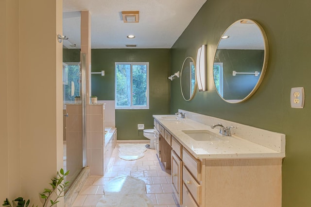 full bathroom with tile patterned floors, vanity, toilet, and independent shower and bath