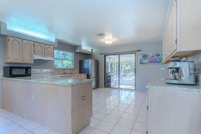 kitchen with light tile patterned flooring, light brown cabinetry, white range with electric stovetop, stainless steel fridge, and kitchen peninsula