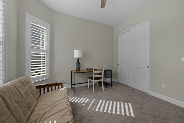 carpeted home office with ceiling fan