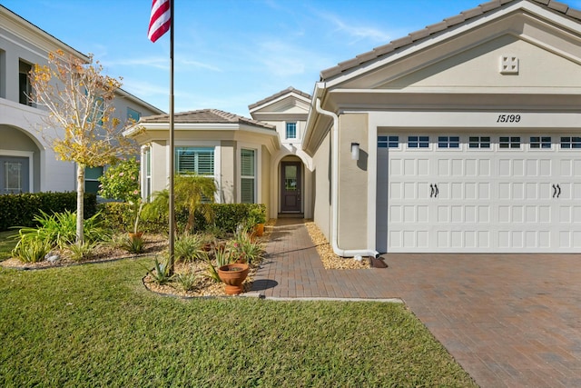 view of front of property with a garage and a front yard